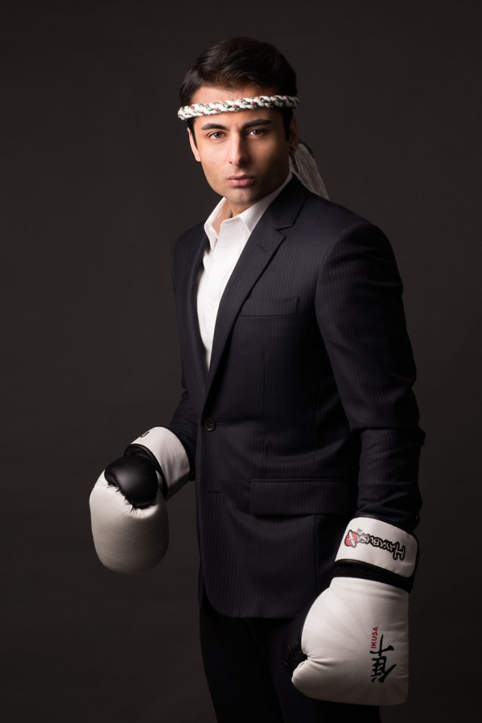 studio portrait of business man in suit with boxing gloves
