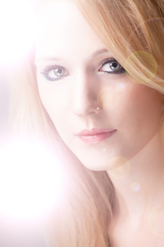 Artistic portrait of blonde women with light flare