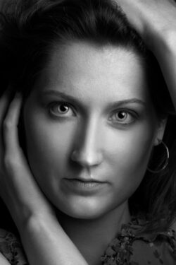 Professional black and white female headshot with dramatic studio lighting, captured by a Toronto portrait photographer.
