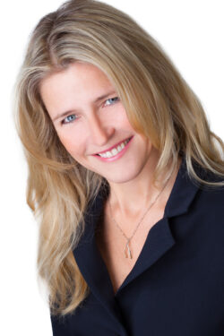 High-key professional corporate headshot of a smiling woman on a white background, captured by a Toronto business portrait photographer.